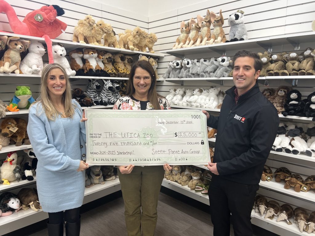 Carly Steet Mathias, left; Andria Heath, Utica Zoo Director, middle; Joe Steet Jr., right, presenting the Utica Zoo with their $25,000 donation