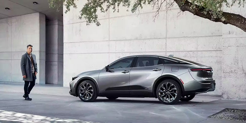 Image of man standing next to a silver Toyota Crown Sedan