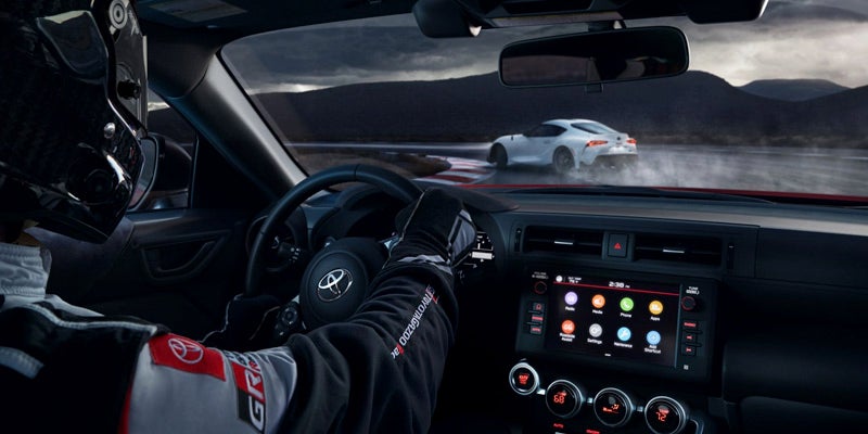 Image of a professional driver on a track racing in a Toyota GR86