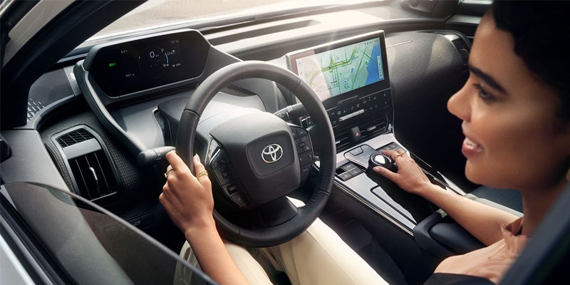 Interior image of a woman driving a Toyota bZ4X