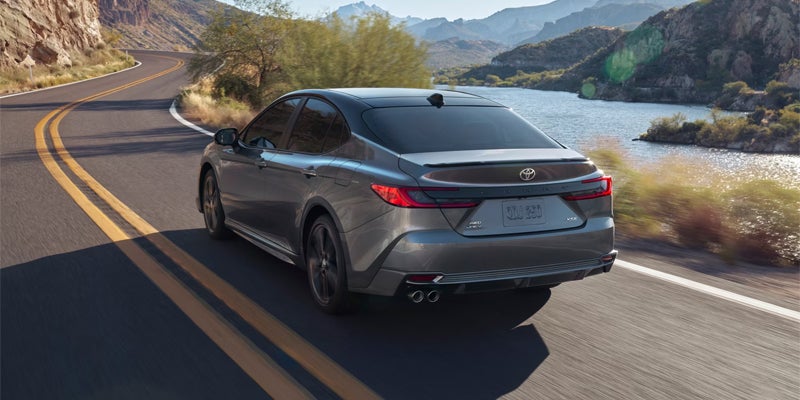 Exterior image of silver 2025 Toyota Camry driving on road